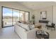 Stylish living room with a modern fireplace, large sliding glass doors, and contemporary furnishings at 12328 E Black Rock Rd, Scottsdale, AZ 85255