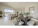 Airy living space featuring a modern fireplace, sleek dining set, and plush sofas under recessed lighting at 12328 E Black Rock Rd, Scottsdale, AZ 85255