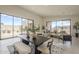 Bright, open-concept living area with large windows, a dining table, and comfortable seating arrangements at 12328 E Black Rock Rd, Scottsdale, AZ 85255