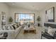 Bright living room featuring a modern fireplace, neutral sofas, and large windows with lovely views at 12328 E Black Rock Rd, Scottsdale, AZ 85255