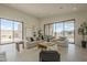 Bright living area with floor-to-ceiling windows, stylish seating, and chic decor under ample natural light at 12328 E Black Rock Rd, Scottsdale, AZ 85255