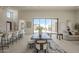 Spacious living area with bar seating at the kitchen island and a dining table with chairs and benches at 12328 E Black Rock Rd, Scottsdale, AZ 85255