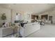 Open-concept living space featuring a fireplace, kitchen island, and a dining area for modern living at 12328 E Black Rock Rd, Scottsdale, AZ 85255
