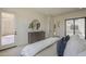 Bright main bedroom with a sliding glass door, modern dresser, and elegant furnishings at 12328 E Black Rock Rd, Scottsdale, AZ 85255