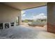 Covered patio features stone floors, an outdoor kitchen area, and overlooks a pool area at 12328 E Black Rock Rd, Scottsdale, AZ 85255