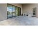Covered patio featuring stone tile flooring and an outdoor kitchen area with built-in grill at 12328 E Black Rock Rd, Scottsdale, AZ 85255