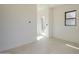 Room with natural light through a window and door, complemented by neutral paint and tile flooring at 12328 E Black Rock Rd, Scottsdale, AZ 85255
