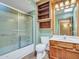 Bathroom featuring a walk-in shower, wood cabinet, and large mirror at 12519 W Castle Rock Dr, Sun City West, AZ 85375