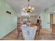 Inviting dining area with a chandelier and a view of the living room and kitchen at 12519 W Castle Rock Dr, Sun City West, AZ 85375
