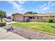 Beautiful home featuring a green lawn, desert landscaping, and a prominent real estate sign at 12519 W Castle Rock Dr, Sun City West, AZ 85375
