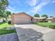 Lovely single-story home with a wide driveway, attached garage, and well-maintained landscaping at 12519 W Castle Rock Dr, Sun City West, AZ 85375
