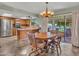 Open-concept kitchen with stainless steel appliances and a dining table with chairs at 12519 W Castle Rock Dr, Sun City West, AZ 85375