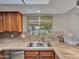 Kitchen sink and window that provides natural light and outdoor views at 12519 W Castle Rock Dr, Sun City West, AZ 85375