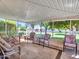 Enclosed patio featuring multiple seating areas with views of the landscaped backyard at 12519 W Castle Rock Dr, Sun City West, AZ 85375