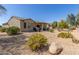 Backyard showcasing desert landscaping with a covered patio perfect for outdoor entertaining and relaxation at 15074 W Cactus Ridge Way, Surprise, AZ 85374