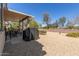 Spacious backyard features a covered patio, desert landscaping, and gravel ground cover for low maintenance at 15074 W Cactus Ridge Way, Surprise, AZ 85374