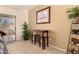 Cozy dining area next to patio doors with a wooden table, and bar stool seating at 15074 W Cactus Ridge Way, Surprise, AZ 85374
