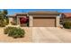 Charming home featuring a two-car garage, manicured front yard, and a desert-style landscape at 15074 W Cactus Ridge Way, Surprise, AZ 85374