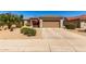 Charming single-story home with a well-manicured desert landscape and a spacious two car garage at 15074 W Cactus Ridge Way, Surprise, AZ 85374