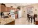 Open kitchen with wood cabinets, granite counters, and stainless appliances at 15074 W Cactus Ridge Way, Surprise, AZ 85374