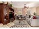 Comfortable living room with plush seating, ceiling fan, and neutral decor at 15074 W Cactus Ridge Way, Surprise, AZ 85374