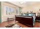 Sunlit main bedroom boasts hardwood floors, plantation shutters, and a comfortable seating bench by the bay windows at 15074 W Cactus Ridge Way, Surprise, AZ 85374