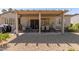 Enjoy outdoor dining on this covered patio featuring comfortable seating, a table, and desert landscaping at 15074 W Cactus Ridge Way, Surprise, AZ 85374