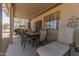 Enjoy outdoor dining on this covered patio featuring comfortable seating, a table, and desert landscaping at 15074 W Cactus Ridge Way, Surprise, AZ 85374