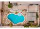 Aerial view showcasing a swimming pool, pergola, patio, and landscaping in the backyard at 15123 W Custer Ln, Surprise, AZ 85379