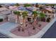 Stunning aerial view of a home highlighting solar panels, mature palm trees, a private backyard with a waterfall feature at 15123 W Custer Ln, Surprise, AZ 85379