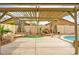 Desert backyard with large concrete patio, pergola and desert landscaping at 15123 W Custer Ln, Surprise, AZ 85379
