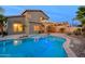 Backyard showcasing a private pool and outdoor kitchen with a covered patio, perfect for entertaining at 15123 W Custer Ln, Surprise, AZ 85379