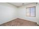 Bedroom featuring a neutral carpet and a window offering natural light at 15123 W Custer Ln, Surprise, AZ 85379