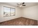 Bedroom with a ceiling fan and window offering natural light at 15123 W Custer Ln, Surprise, AZ 85379