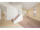 Bright entryway featuring tile flooring, a staircase with white railing, and large windows allowing natural light at 15123 W Custer Ln, Surprise, AZ 85379