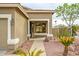 Inviting covered front porch with neutral columns, desert landscaping, and mature palm trees enhancing curb appeal at 15123 W Custer Ln, Surprise, AZ 85379