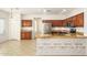 Bright eat-in kitchen featuring stainless appliances, wooden cabinetry, and granite countertops at 15123 W Custer Ln, Surprise, AZ 85379