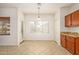Eat-in kitchen features natural light, wooden cabinetry, and tile flooring at 15123 W Custer Ln, Surprise, AZ 85379