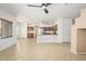 Open-concept space showcasing tile floors, natural light, and views of the kitchen at 15123 W Custer Ln, Surprise, AZ 85379