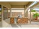 Covered outdoor kitchen featuring a built-in grill and stone accents, ideal for entertaining and outdoor cooking at 15123 W Custer Ln, Surprise, AZ 85379