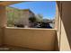 Balcony view overlooking community parking with lush trees and well-maintained landscape at 16013 S Desert Foothills Pkwy # 1050, Phoenix, AZ 85048