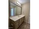 Bright bathroom features a vanity with cream countertops and cabinets with a large mirror at 16013 S Desert Foothills Pkwy # 1050, Phoenix, AZ 85048