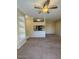 Open concept living room with a ceiling fan, breakfast bar, and adjacent built-in shelving at 16013 S Desert Foothills Pkwy # 1050, Phoenix, AZ 85048