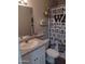 Stylish bathroom featuring modern vanity, decorative shelves, and a unique shower curtain at 1875 N St Francis Pl, Casa Grande, AZ 85122