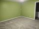 Bedroom featuring green walls, carpet, and a view into the attached bathroom at 1875 N St Francis Pl, Casa Grande, AZ 85122