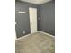 Neutral bedroom featuring gray walls, carpet and a white door leading to the closet space at 1875 N St Francis Pl, Casa Grande, AZ 85122