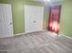 Bedroom showing carpet, a window with red curtains and a closet with white doors at 1875 N St Francis Pl, Casa Grande, AZ 85122