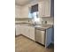 Bright kitchen featuring stainless steel dishwasher, sink and white cabinetry at 1875 N St Francis Pl, Casa Grande, AZ 85122