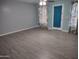 Light-filled living room boasts neutral gray walls and light wood-look flooring at 1875 N St Francis Pl, Casa Grande, AZ 85122