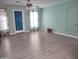 Spacious living room with light wood-look flooring and colorful patterned curtains at 1875 N St Francis Pl, Casa Grande, AZ 85122